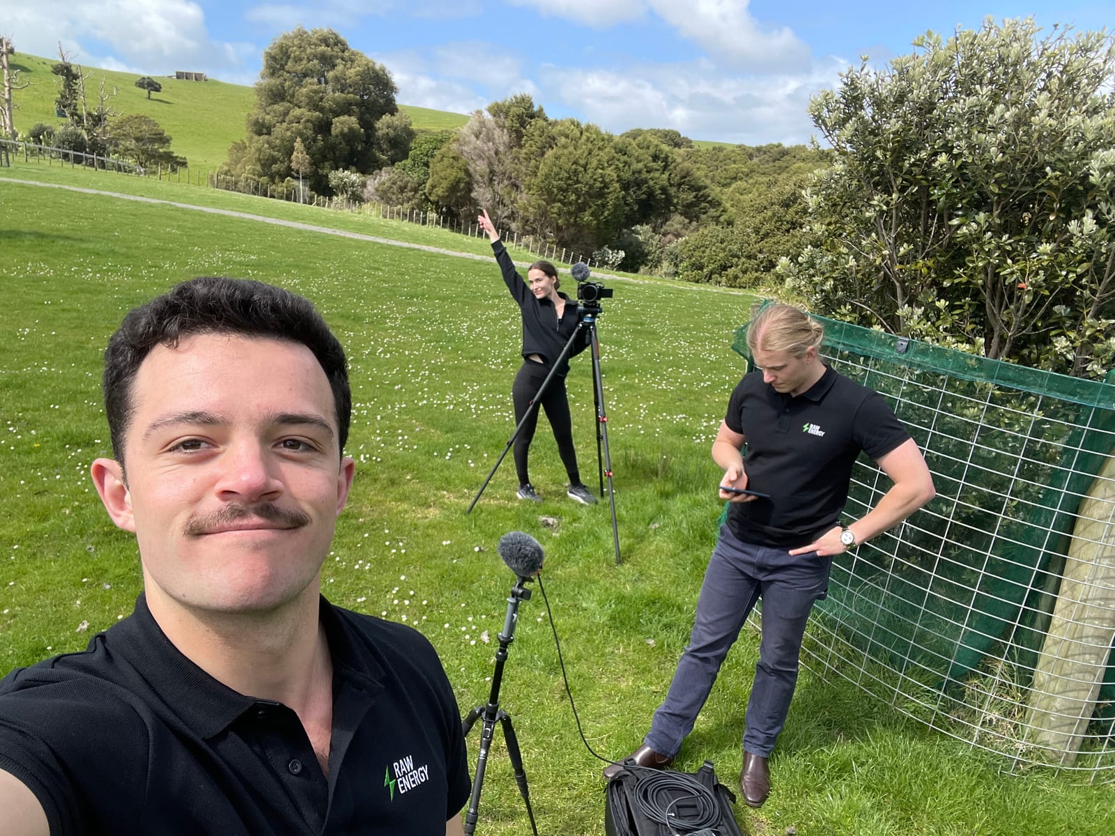 Isaac filming a promotional shoot in Raw Energy branded clothing in a paddock